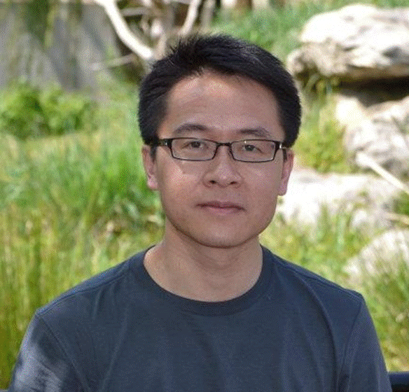 A person wearing glasses and a black shirt

Description automatically generated